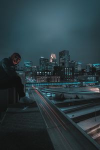 Preview wallpaper man, mask, roof, city, night