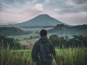 Preview wallpaper man, mountain, volcano, nature, landscape