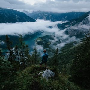 Preview wallpaper man, mountains, clouds, travel