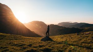 Preview wallpaper man, mountains, hill, sunlight