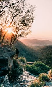 Preview wallpaper man, mountains, rocks, stream, landscape