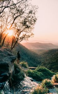 Preview wallpaper man, mountains, rocks, stream, landscape