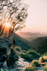Preview wallpaper man, mountains, rocks, stream, landscape