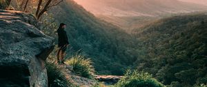 Preview wallpaper man, mountains, rocks, stream, landscape