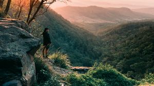 Preview wallpaper man, mountains, rocks, stream, landscape