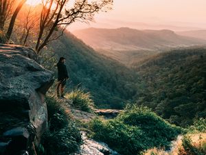 Preview wallpaper man, mountains, rocks, stream, landscape