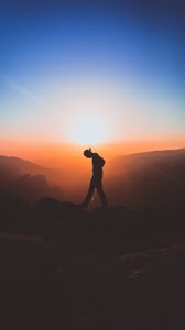 Preview wallpaper man, mountains, silhouette, sunset, solitude, freedom