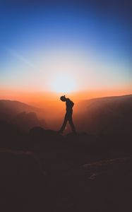 Preview wallpaper man, mountains, silhouette, sunset, solitude, freedom