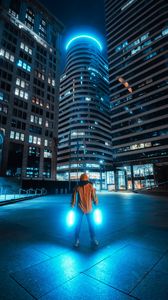 Preview wallpaper man, neon, light, city, night, buildings