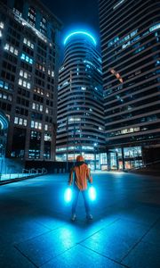 Preview wallpaper man, neon, light, city, night, buildings