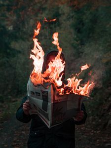 Preview wallpaper man, newspaper, fire, flame