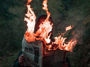 Preview wallpaper man, newspaper, fire, flame