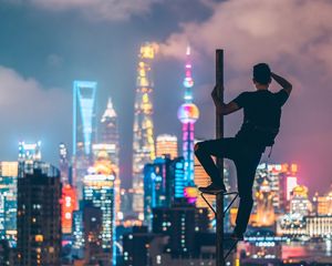 Preview wallpaper man, night city, view, overview, building, lights