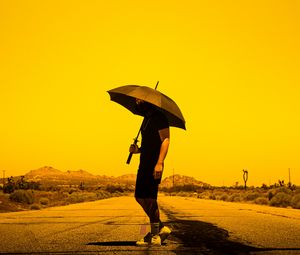 Preview wallpaper man, person, umbrella, road, sunset