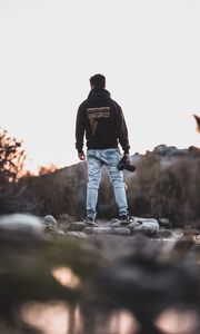 Preview wallpaper man, photographer, mountains, stones, nature