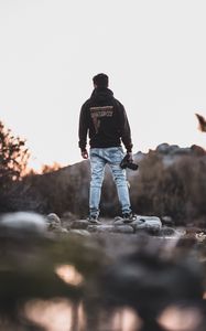 Preview wallpaper man, photographer, mountains, stones, nature