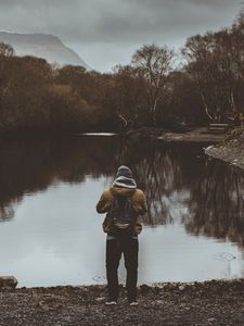 Preview wallpaper man, pond, cloudy, trees, gloomy