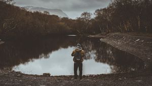 Preview wallpaper man, pond, cloudy, trees, gloomy