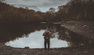 Preview wallpaper man, pond, cloudy, trees, gloomy