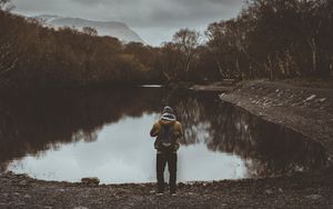 Preview wallpaper man, pond, cloudy, trees, gloomy