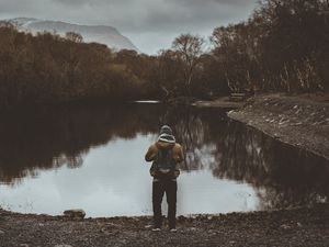 Preview wallpaper man, pond, cloudy, trees, gloomy