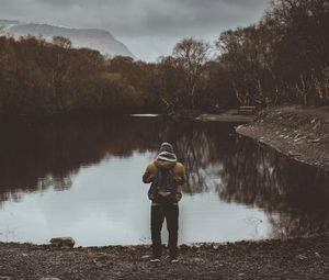 Preview wallpaper man, pond, cloudy, trees, gloomy