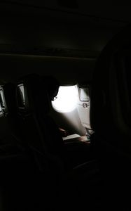 Preview wallpaper man, porthole, airplane, dark, rays