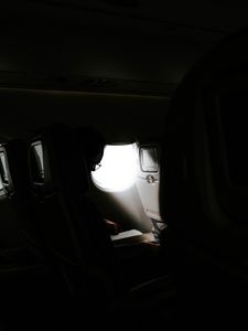 Preview wallpaper man, porthole, airplane, dark, rays