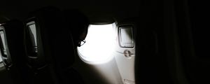 Preview wallpaper man, porthole, airplane, dark, rays