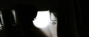 Preview wallpaper man, porthole, airplane, dark, rays