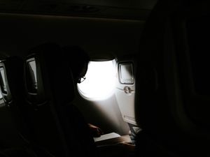 Preview wallpaper man, porthole, airplane, dark, rays