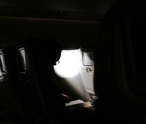 Preview wallpaper man, porthole, airplane, dark, rays