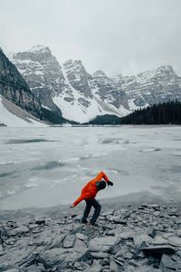 Preview wallpaper man, pose, mountains, snow, snowy