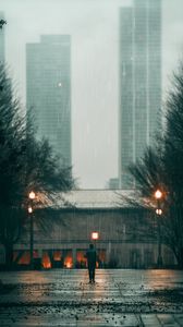 Preview wallpaper man, rain, loneliness, sad, walk, street, city