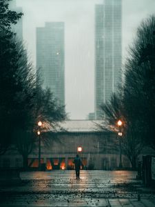 Preview wallpaper man, rain, loneliness, sad, walk, street, city