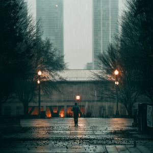 Preview wallpaper man, rain, loneliness, sad, walk, street, city