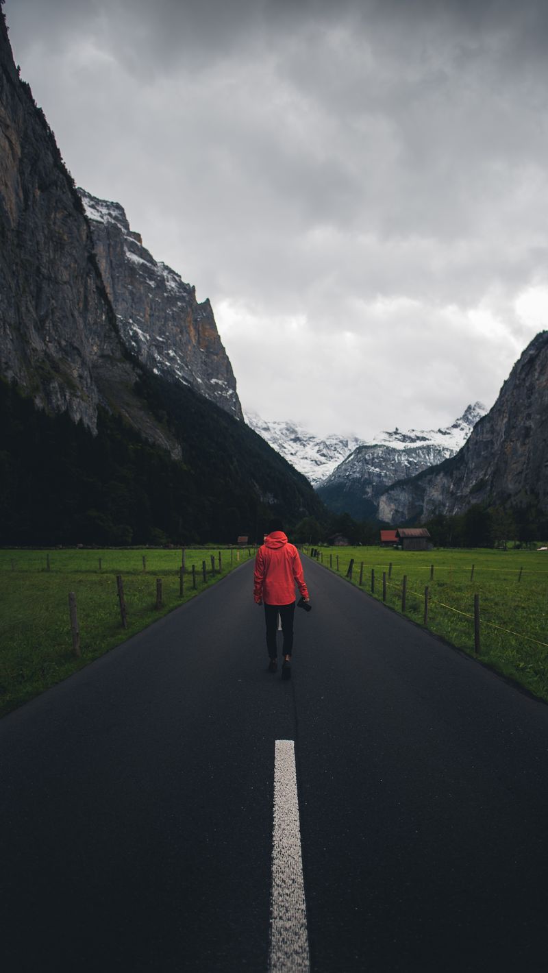 800x1420 Wallpaper man, road, mountains, clouds