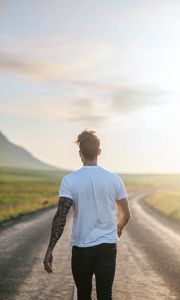 Preview wallpaper man, road, sunlight, walk, nature