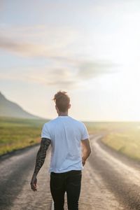 Preview wallpaper man, road, sunlight, walk, nature