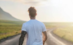 Preview wallpaper man, road, sunlight, walk, nature