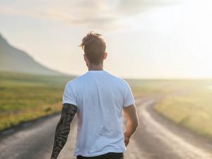 Preview wallpaper man, road, sunlight, walk, nature