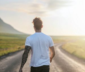Preview wallpaper man, road, sunlight, walk, nature