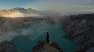 Preview wallpaper man, rock, cliff, lake, mountains