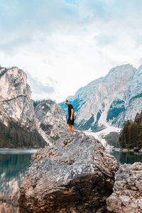 Preview wallpaper man, rock, mountains, lake, nature