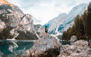 Preview wallpaper man, rock, mountains, lake, nature