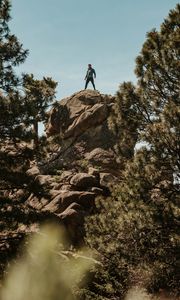 Preview wallpaper man, rock, trees, stones, height