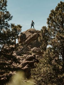 Preview wallpaper man, rock, trees, stones, height