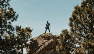 Preview wallpaper man, rock, trees, stones, height
