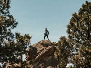 Preview wallpaper man, rock, trees, stones, height