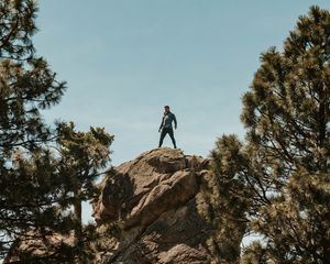 Preview wallpaper man, rock, trees, stones, height
